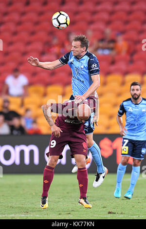 Brisbane, QUEENSLAND, AUSTRALIA. 8th Jan, 2018. Alexander Wilkinson of Sydney (4, top) and Massimo Maccarone of the Roar (9) compete for the ball during the round fifteen Hyundai A-League match between the Brisbane Roar and Sydney FC at Suncorp Stadium on Monday, January 8, 2018 in Brisbane, Australia. Credit: Albert Perez/ZUMA Wire/Alamy Live News Stock Photo