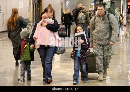 Photos by:  Lt. Col. Hank McIntire   DRAPER, Utah — Approximately 60 soldiers of the Utah Army National Guard’s 2nd Battalion, 211th Aviation, departed Utah on the first leg of their 12-month deployment to Kosovo Saturday, Nov. 23 and Sunday, 24, 2013.   The first group of soldiers departed via UH-60 Blackhawk helicopters Saturday, Nov. 23, at 10 a.m. from the Utah Guard’s Army Aviation Support Facility in West Jordan.  Remaining soldiers departed Sunday, Nov. 24, from Salt Lake International Airport via commercial aircraft.   Soldiers will first travel to Fort Hood, Texas, for several weeks o Stock Photo