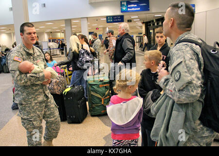 Photos by:  Lt. Col. Hank McIntire   DRAPER, Utah — Approximately 60 soldiers of the Utah Army National Guard’s 2nd Battalion, 211th Aviation, departed Utah on the first leg of their 12-month deployment to Kosovo Saturday, Nov. 23 and Sunday, 24, 2013.   The first group of soldiers departed via UH-60 Blackhawk helicopters Saturday, Nov. 23, at 10 a.m. from the Utah Guard’s Army Aviation Support Facility in West Jordan.  Remaining soldiers departed Sunday, Nov. 24, from Salt Lake International Airport via commercial aircraft.   Soldiers will first travel to Fort Hood, Texas, for several weeks o Stock Photo