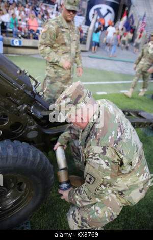 US Army National Guard soldier loading howitzer at ceremonial event. Stock Photo