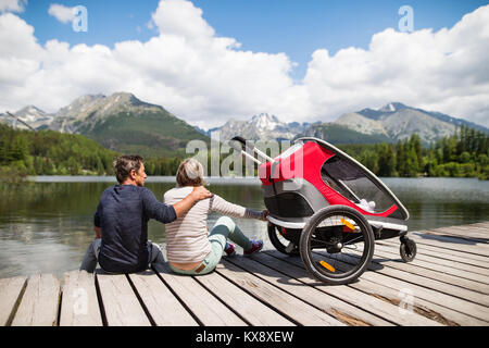 Senior couple with jogging stroller, summer day. Stock Photo