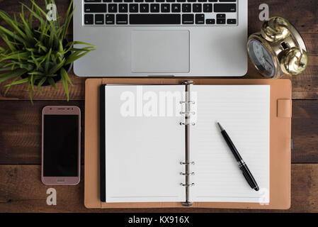 Pen, smartphone, clock, notebook, laptop on wooden table - journalist concept Stock Photo