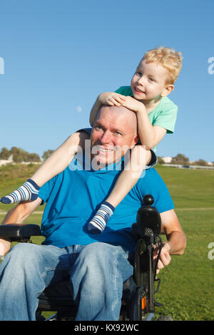 Disabled father giving little son piggyback ride