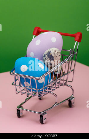 Multicolored easter eggs in a trolley, close-up Stock Photo