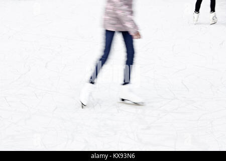 Arty blurry two teenage girl ice skating legs , fun and winter recreation detail Stock Photo