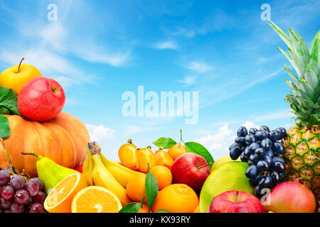 Large collection of fruits and vegetables on a blue sky background. Healthy food. Copy Space for your text. Stock Photo