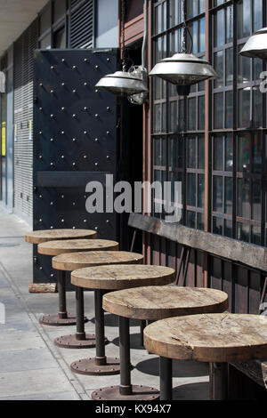 London, UK - August 17, 2017: Tables outside at the urban cafe with modern lamps in the Art Nouveau style Stock Photo