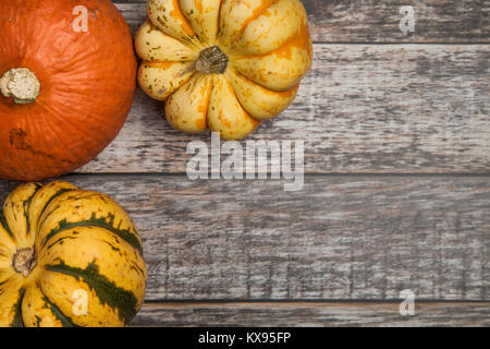 Top view of 3 various squash varieties on a wooden table Stock Photo