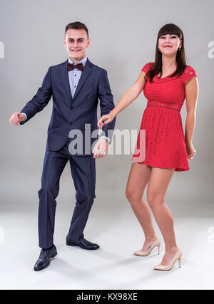 Teenage couple dressed in formal party clothing, dancing Stock Photo