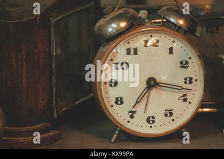 Vintage background with old retro alarm clock on table Stock Photo
