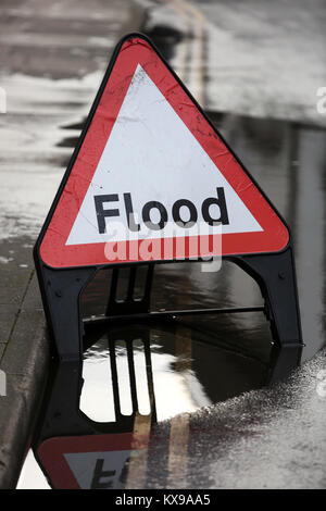 A Flood Warning triangle pictured sitting in a small flood in ...