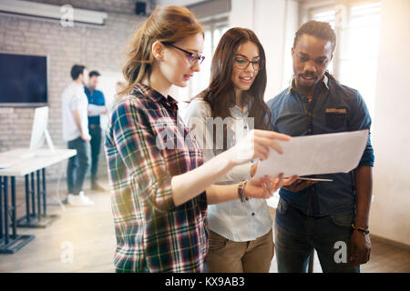 Picture of group of young perspective designers discussing Stock Photo