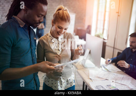 Picture of young designers discussing in office Stock Photo