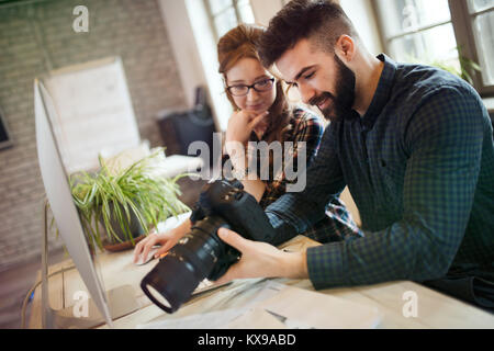 Picture of young attractive designers looking at camera Stock Photo
