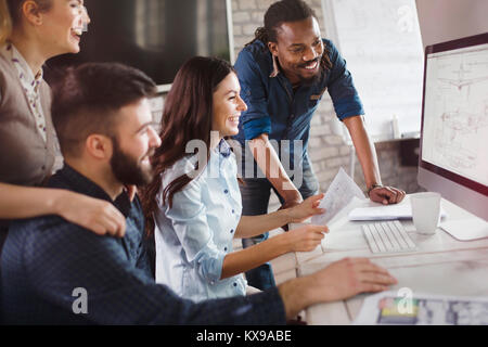 Group of young designers working as team Stock Photo