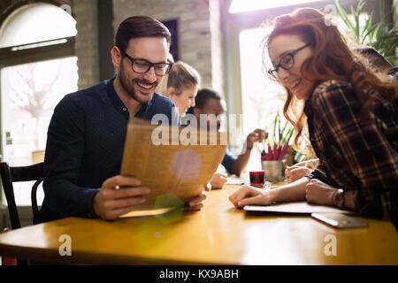 Happy colleagues from work socializing in restaurant Stock Photo