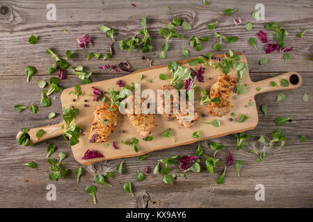 Fresh freshly fried delicious slices of meat on a wooden board with fresh herbs. Appetizing steaks on a wooden board. Stock Photo