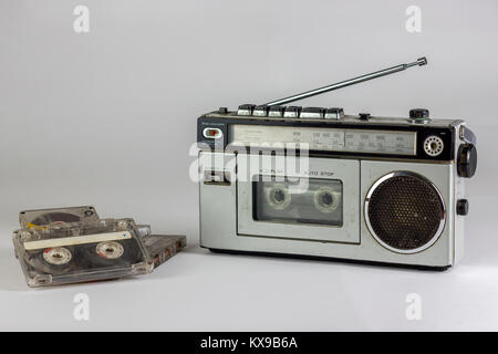 old radio and cassette recorder with cassettes isolated on white background Stock Photo