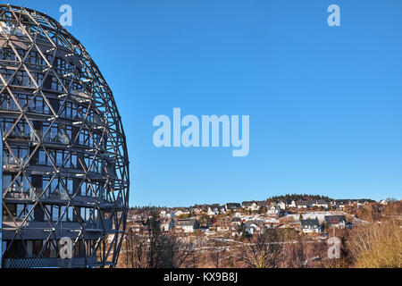 WINTERBERG, GERMANY - FEBRUARY 14, 2017: Futuristic egg shaped framework hotel building in front of small villas Stock Photo
