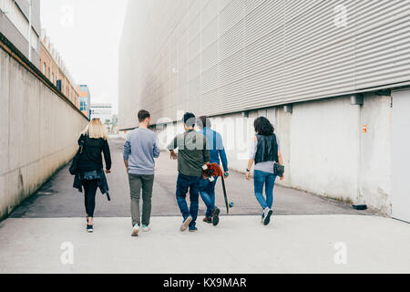 back view group of friends multiethnic walking outdoor having fun - friendship, interaction, getting away form it all concept Stock Photo