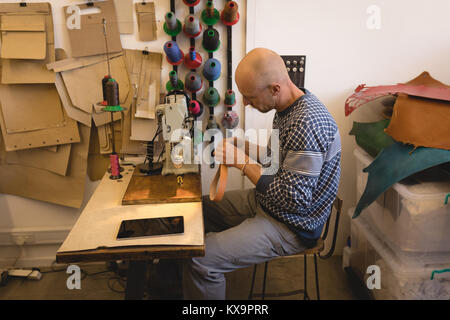 Worker holding leather scraps Stock Photo