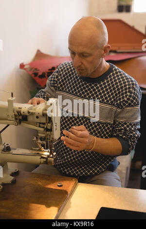 Worker using sewing machine Stock Photo