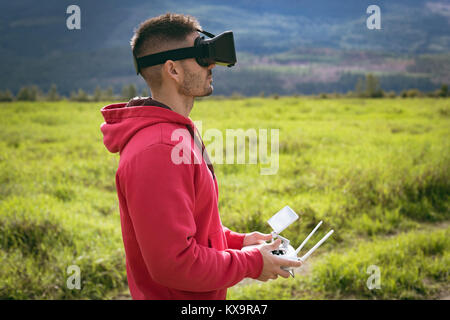 Man wearing virtual reality glasses and controlling drone Stock Photo