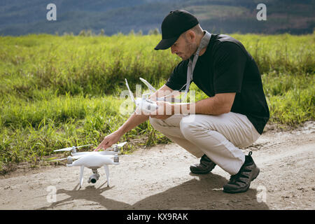 Man checking drone before take off Stock Photo