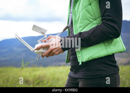 Two female hands holding remote control Stock Photo