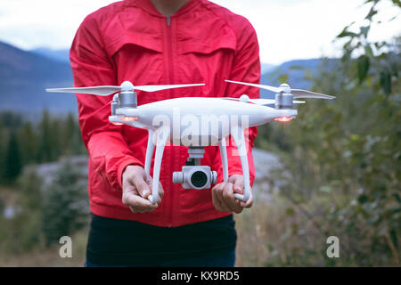 Woman holding drone in her hands Stock Photo