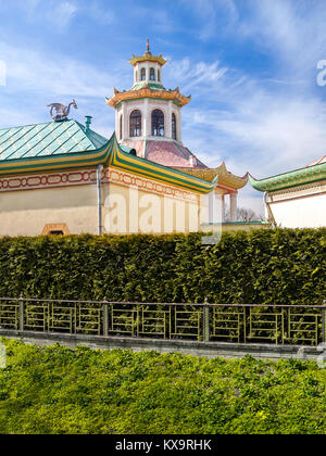 A Chinese-style pavilion with a dragon on the roof and a green fence made of thuya in the Alexander Park in Pushkin in St. Petersburg in the early spr Stock Photo