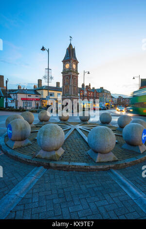 Newmarket Suffolk, view at dusk of the Queen Victoria Jubilee Clock Tower and roundabout at the north end of Newmarket High Street, Suffolk, UK. Stock Photo