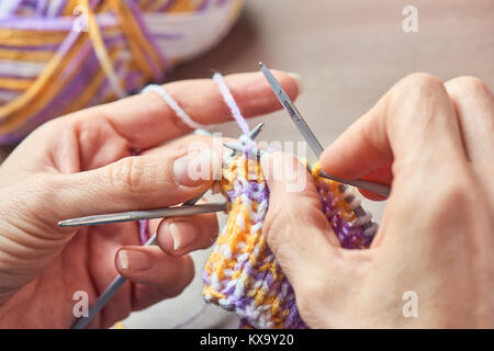 Young Woman Knitting - Knitting inspiration is at your fingertips Stock Photo