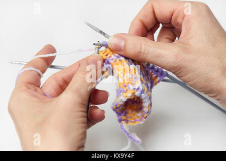 Young Woman Knitting - Knitting inspiration is at your fingertips - isolated on white background Stock Photo