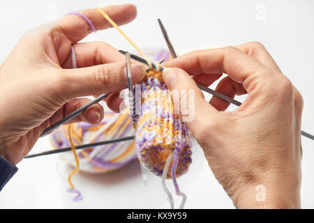 Young Woman Knitting - Knitting inspiration is at your fingertips - isolated on white background Stock Photo