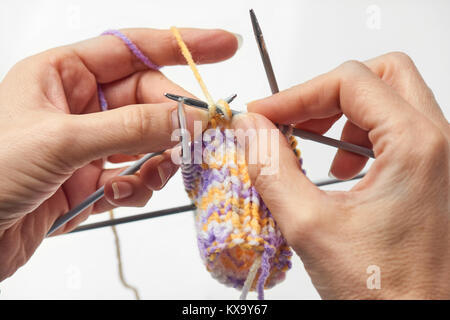 Young Woman Knitting - Knitting inspiration is at your fingertips - isolated on white background Stock Photo