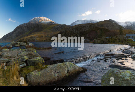 Snow capped peak of Tryfan reflected in the lake of Llyn Ogwen, Snowdonia National Park, Wales Stock Photo