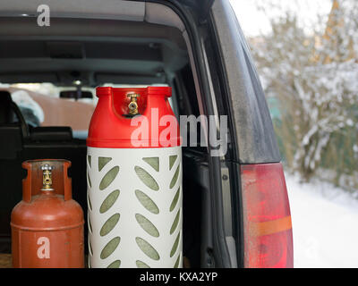 LPG gas bottles loaded into a car boot, winter scene Stock Photo