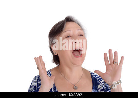 Portrait of elderly woman screaming with her hands on face. Isolated white background  Lady in blue and hands on face screaming Stock Photo