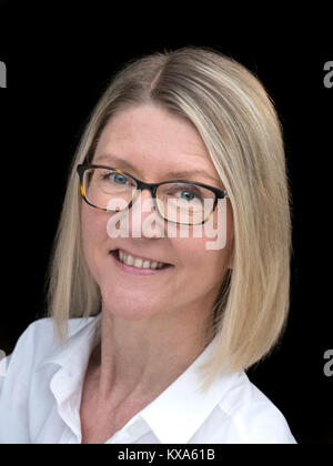 Female Executive Blond 40-45 yrs attractive confident successful executive business woman in white blouse top wearing glasses smiling facing camera Stock Photo