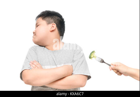 obese fat boy with expression of disgust against vegetables isolated on white background, Refusing food concept Stock Photo