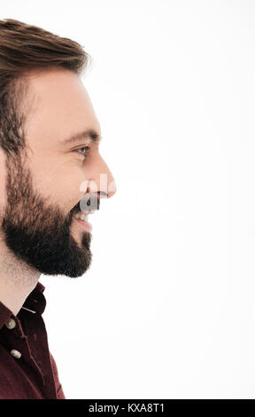 Side view half face portrait of a smiling bearded man laughing and looking away at copy space isolated over white background Stock Photo