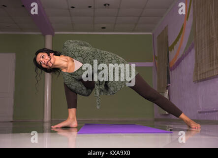 Yoga learner doing yoga in a studio Stock Photo