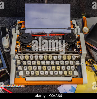 Vintage typewriter on the black background with a lot different items around Stock Photo
