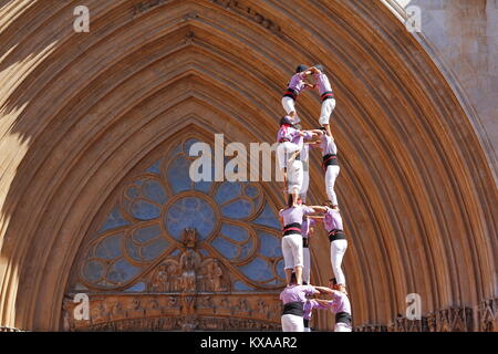 People making human towers in front of the cathedral, a traditional spectacle in Catalonia called 'castellers' Stock Photo