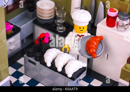Tambov, Russian Federation - January 04, 2018 Lego chef preparing croissant in the kitchen. Studio shot. Stock Photo