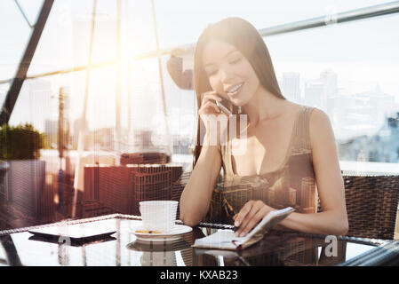 Relaxed girl spending free time in cafe Stock Photo