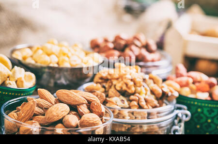 Almonds, peanuts and walnuts in bowls Stock Photo