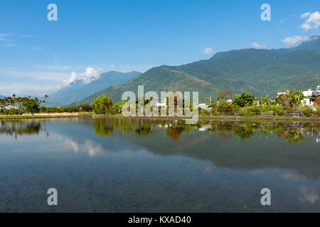 Countryside scene, mountains with rice field and reflection on water in paddy, Ji’an Township, Hualien County, Taiwan Stock Photo