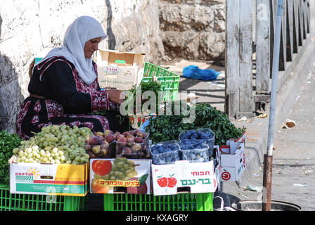 JERUSALEM, ISRAEL - AUGUST 07, 2010: Horizontal picture of muslim woman selling fruits and vegetables in the street of Jerusalem, Israel Stock Photo